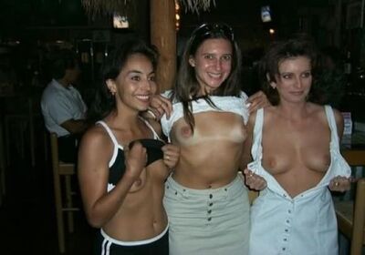 Picture tagged with: Brunette, 3 girls, Boobs, Flashing, Smiling